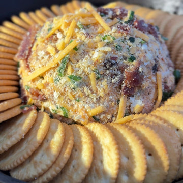 Jalapeño cheese ball dip surrounded by crackers